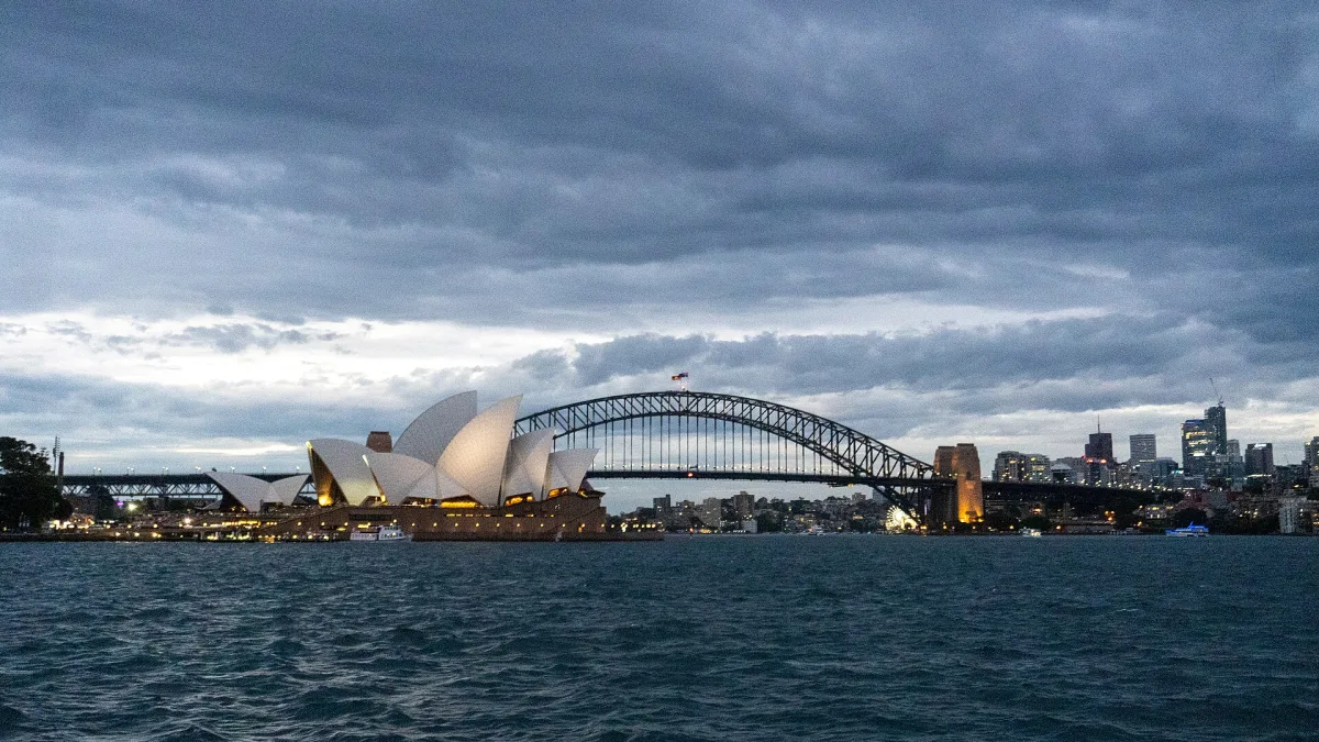 The Sydney Opera House on the harbour, with the Harbour Bridge beyond
