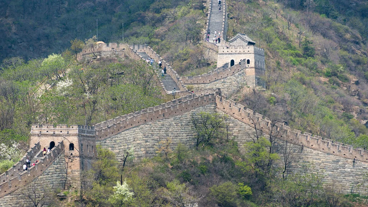 The Great Wall of China winding along a forested ridge at Mutianyu